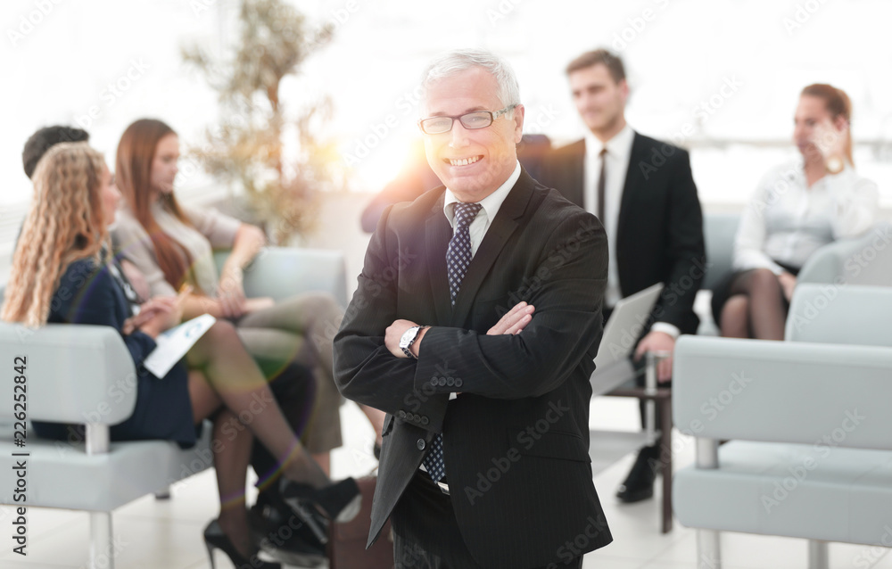 smiling senior businessman on the background of business team smiling senior businessman on the background of business team