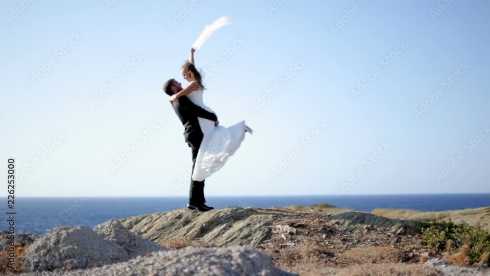 Happy Bride and groom on the seashore on their wedding day. The concept of a happy family life. Wedding photosession. Greece Happy Bride and groom on the seashore on their wedding day. The concept of a happy family life. Wedding photosession. Greece