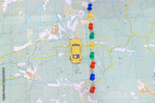 The yellow car travels along the coordinates marked on the geographic map. View from above