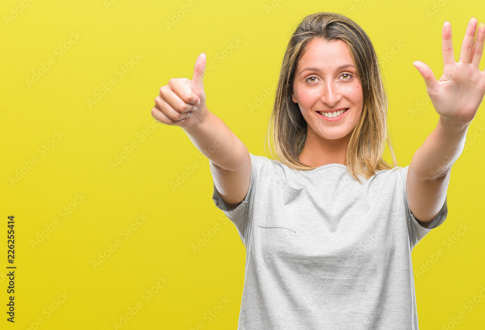 Young beautiful woman over isolated background showing and pointing up with fingers number six while smiling confident and happy. Young beautiful woman over isolated background showing and pointing up with fingers number six while smiling confident and happy.