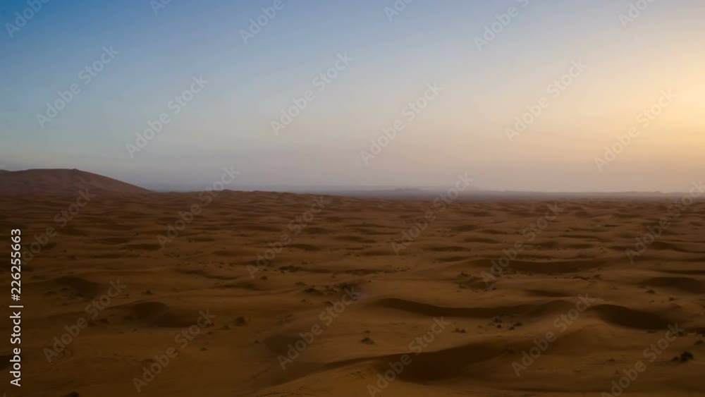 Desert sand dunes ripples during sunrise timelapse. Sahara desert near Merzouga village in Morocco Desert sand dunes ripples during sunrise timelapse. Sahara desert near Merzouga village in Morocco