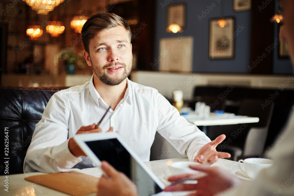 Fototapeta premium Young man on business meeting with colleagues