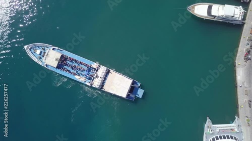 Passenger ferry docking at a Greek island port - One minute top down aerial footage following the procedure. photo