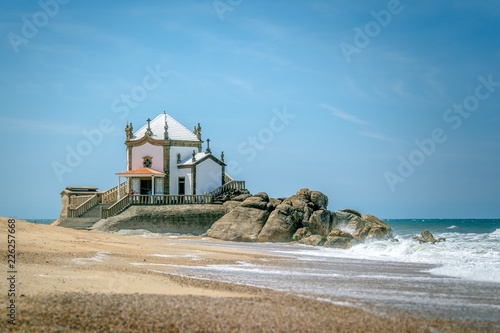 Chapel of Senhor da Pedra on the beach side of Porto, Portugal. It takes 40 minutes by train to get there from São Bento station in the city center. photo