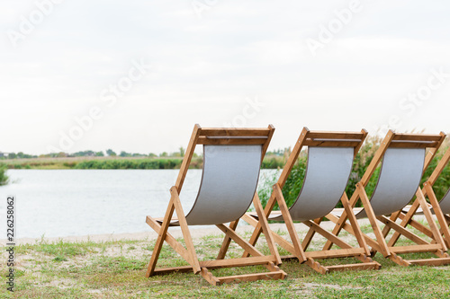 Three white luxury lounge chair near water