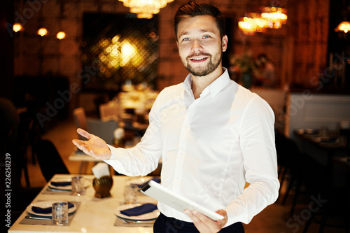 Smiling elegant man with tablet in cafe