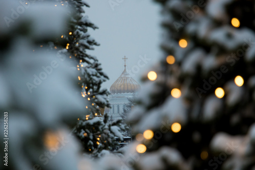Christ the Saviour Cathedral in Moscow, Russia, framed by Christmas trees. Christmas postcard. 