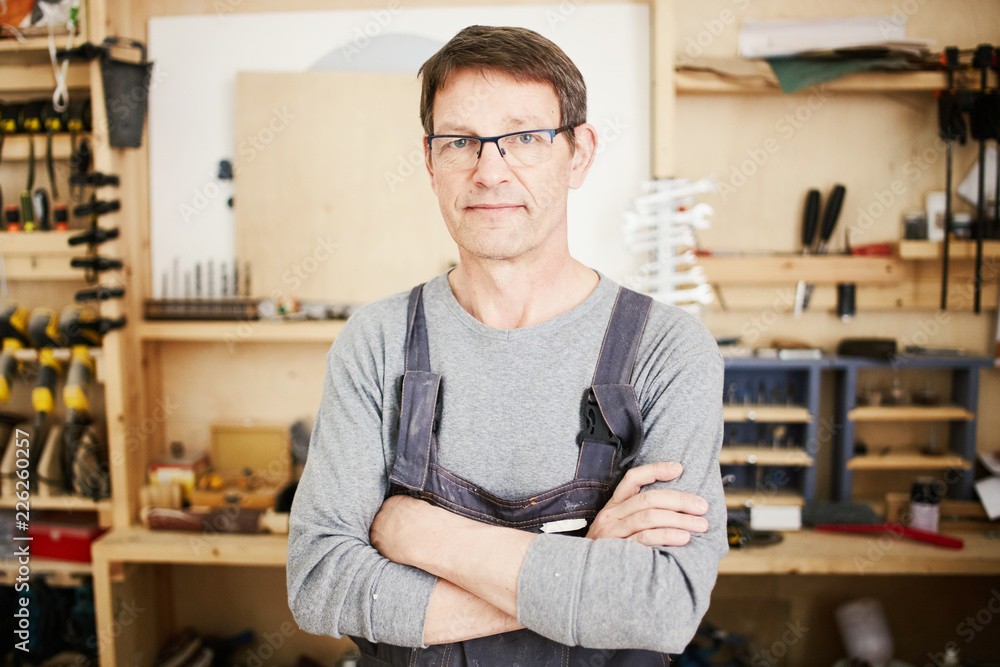 Confident adult craftsman in workshop