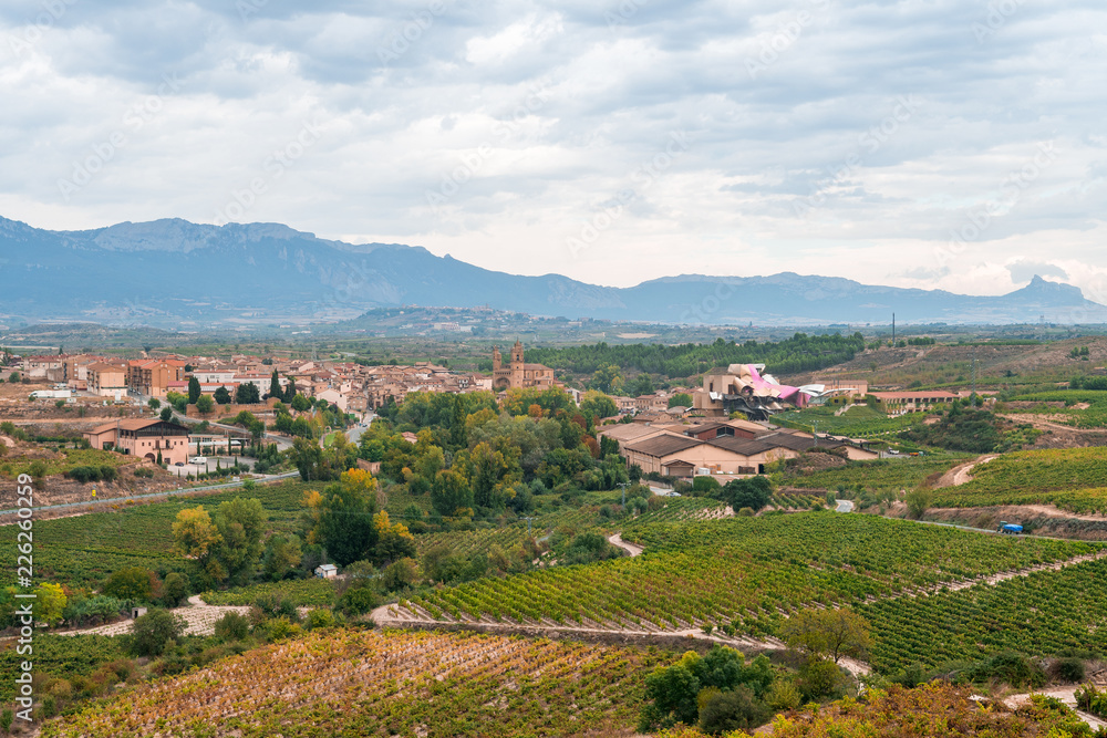 Φωτογραφία countryside town of elciego in la rioja with marques del fiscal winery at backgr