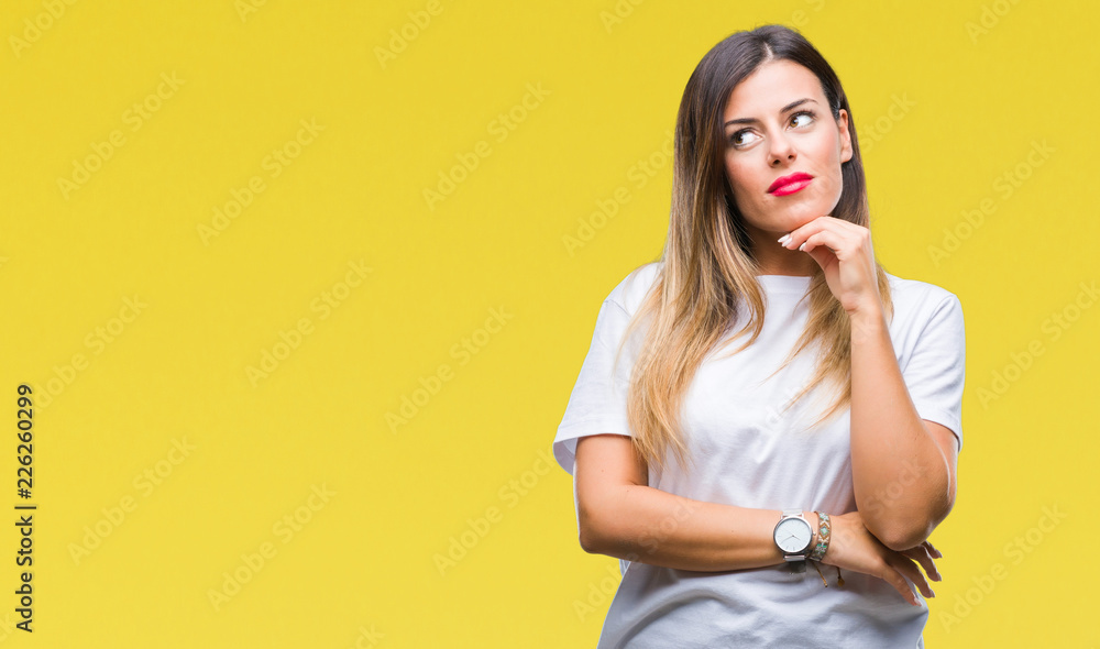 Young beautiful woman casual white t-shirt over isolated background with hand on chin thinking about question, pensive expression. Smiling with thoughtful face. Doubt concept. Young beautiful woman casual white t-shirt over isolated background with hand on chin thinking about question, pensive expression. Smiling with thoughtful face. Doubt concept.