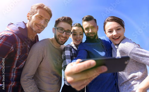 group of young people taking a selfie.