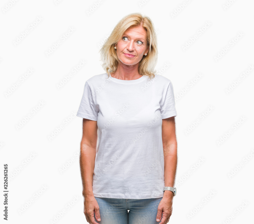 Middle age blonde woman over isolated background smiling looking side and staring away thinking. Middle age blonde woman over isolated background smiling looking side and staring away thinking.