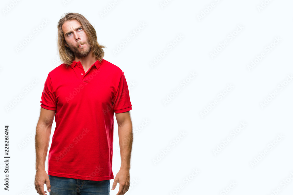 Fototapeta premium Young handsome man with long hair over isolated background making fish face with lips, crazy and comical gesture. Funny expression.