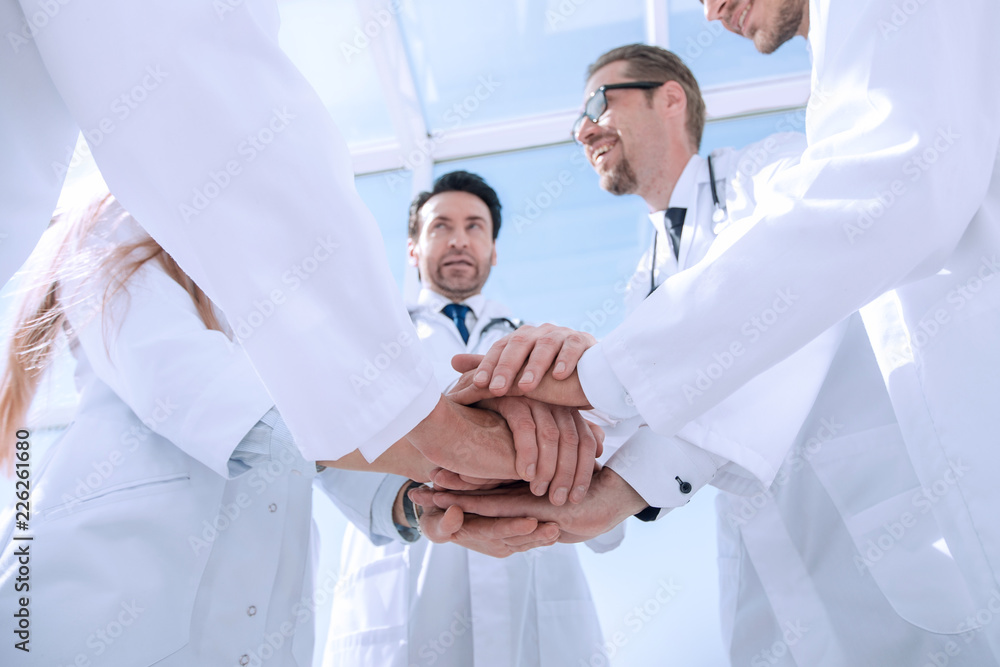 bottom view. close up of a doctors folded their hands together bottom view. close up of a doctors folded their hands together