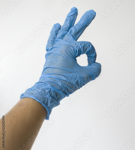 hands in medical gloves (iclose up), hand in gloves, hand in gloves with symbol okay photo