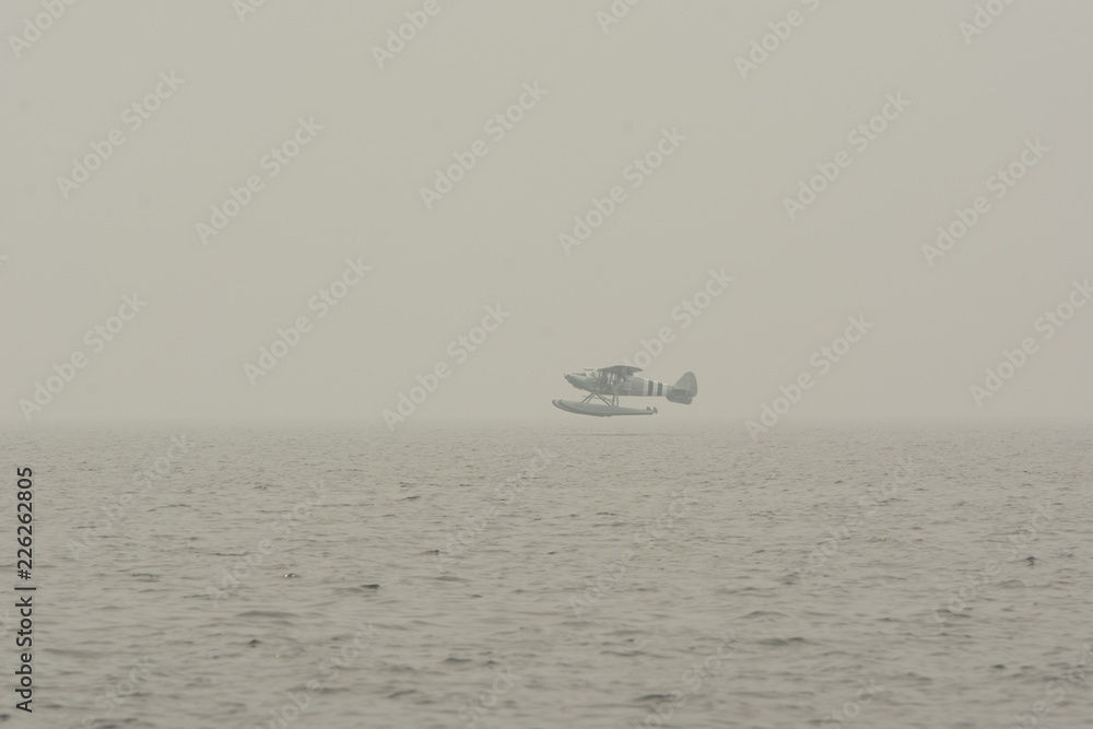 Float plane coming in for a smoky landing. Float plane coming in for a smoky landing.
