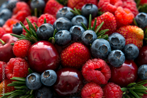Set of various fresh summer berries.  Mix of raspberries  blueberries  cherries  strawberries  blueberries.