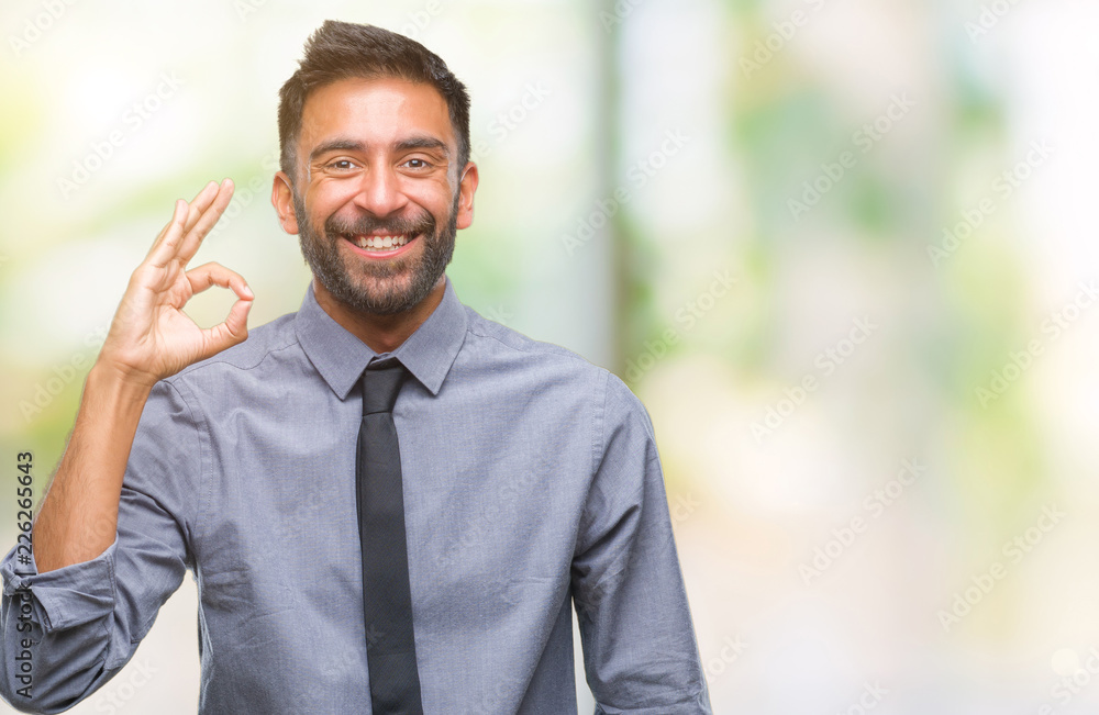 Adult hispanic business man over isolated background smiling positive doing ok sign with hand and fingers. Successful expression. Adult hispanic business man over isolated background smiling positive doing ok sign with hand and fingers. Successful expression.