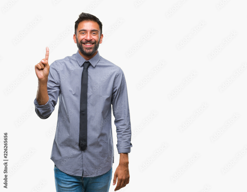 Adult hispanic business man over isolated background showing and pointing up with finger number one while smiling confident and happy. Adult hispanic business man over isolated background showing and pointing up with finger number one while smiling confident and happy.