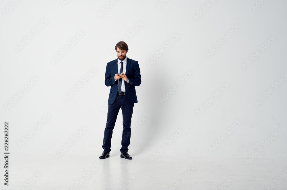 man in a suit in full growth on a light background man in a suit in full growth on a light background