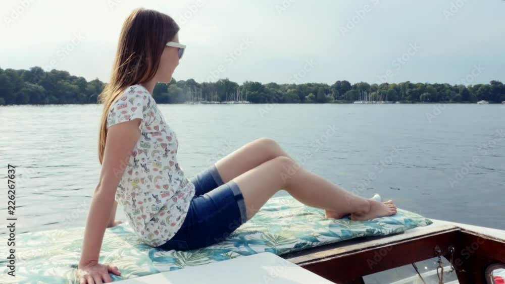 Girl sits on Sail Boat yacht enjoys the sea on a big ship while sailing on sea. Girl sits on Sail Boat yacht enjoys the sea on a big ship while sailing on sea.