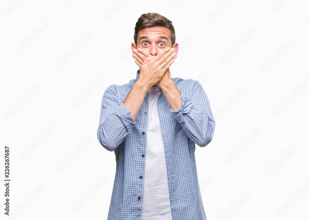 Young handsome man wearing white t-shirt over isolated background shocked covering mouth with hands for mistake. Secret concept. Young handsome man wearing white t-shirt over isolated background shocked covering mouth with hands for mistake. Secret concept.