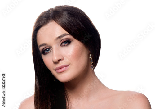 beauty portrait of attractive young caucasian woman brunette isolated on white studio shot face long hair head and shoulders looking at camera makeup brushes