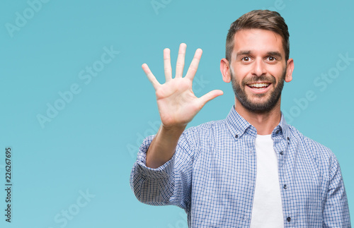 Tablou canvas Young handsome man wearing white t-shirt over isolated background showing and pointing up with fingers number five while smiling confident and happy