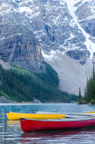Red and yellow canoes on Moraine Lake in Banff National Park, Canada