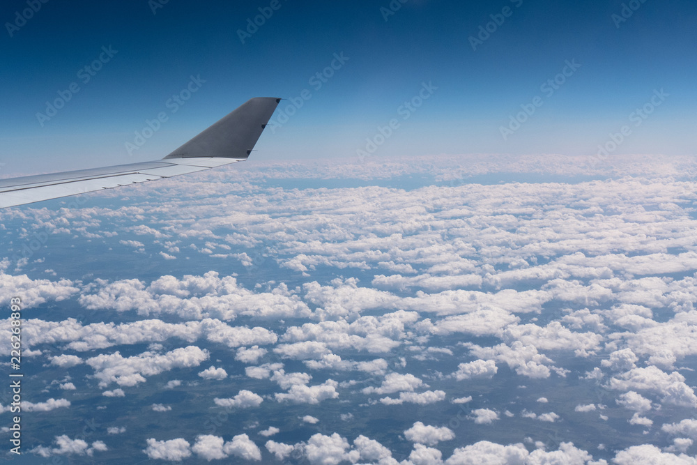 An airbus wing while flying over some clouds. An airbus wing while flying over some clouds.