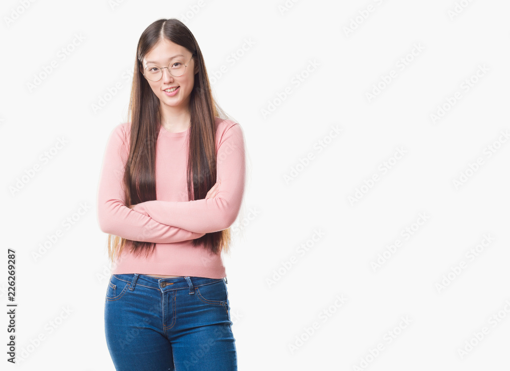 Fototapeta premium Young Chinese woman over isolated background wearing glasses happy face smiling with crossed arms looking at the camera. Positive person.
