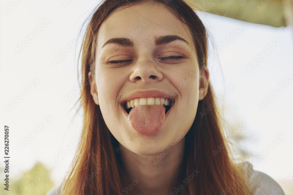 happy woman shows tongue to camera happy woman shows tongue to camera
