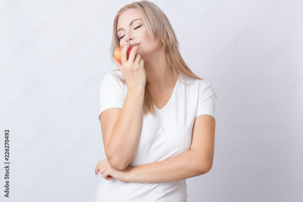 Beautiful blonde woman with apple
