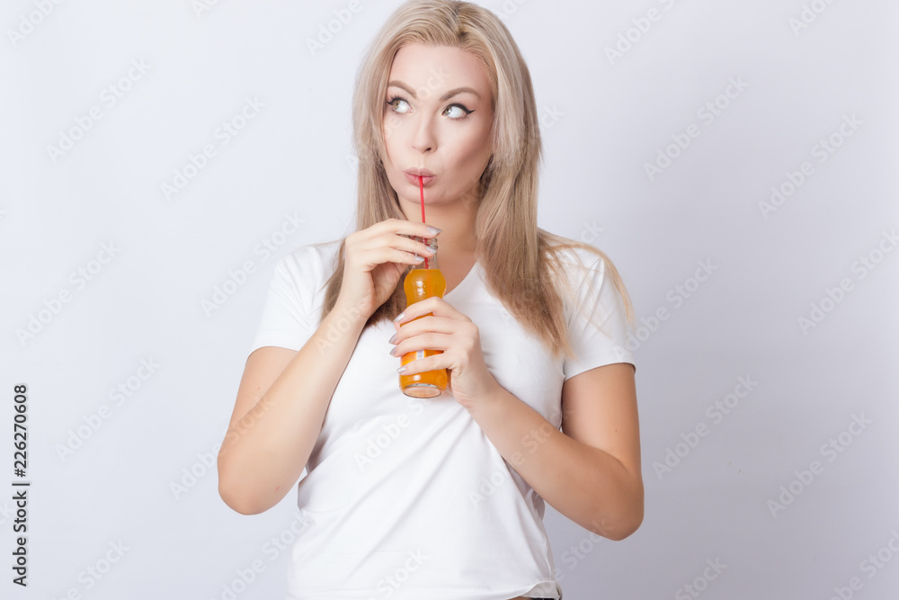 Blonde woman with orange soda in her hands Blonde woman with orange soda in her hands