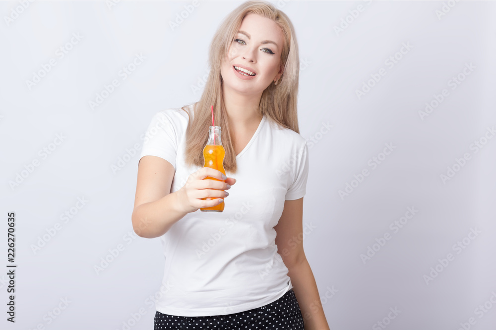 Blonde woman with orange soda in her hands Blonde woman with orange soda in her hands