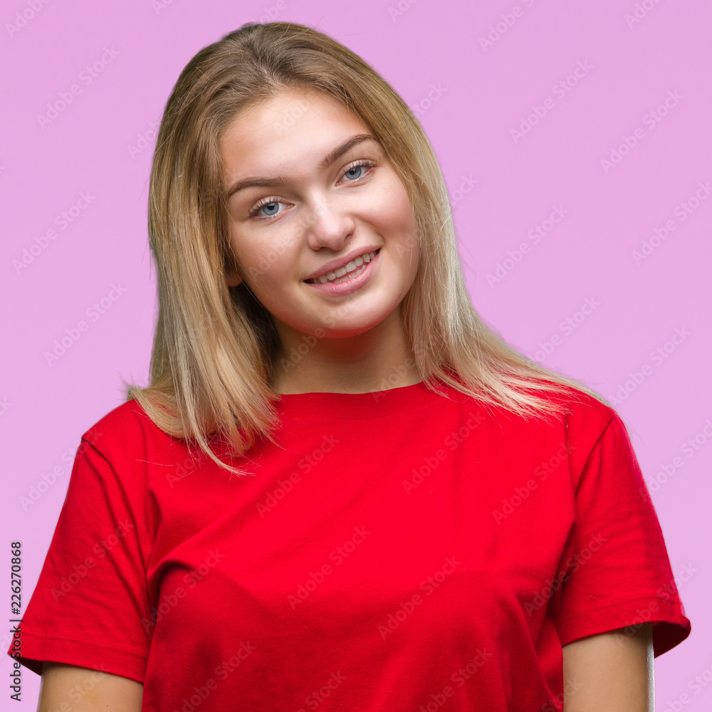 Young caucasian woman over isolated background looking away to side with smile on face, natural expression. Laughing confident. Young caucasian woman over isolated background looking away to side with smile on face, natural expression. Laughing confident.