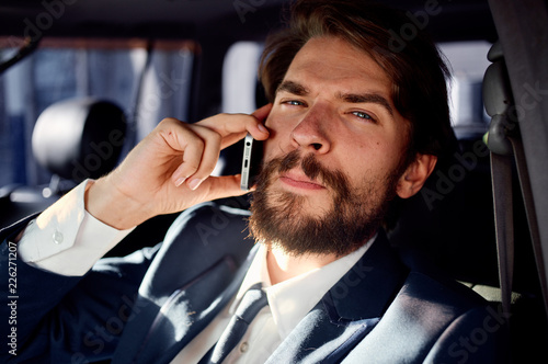 a man with a phone is sitting in the car