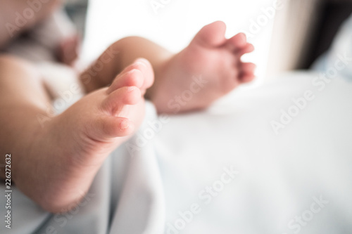 Close up of baby foot on white blanket