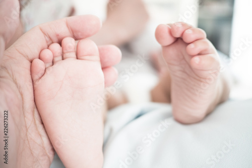 close up of father hand hold baby foot, Concept of love, family, relation © Panithan