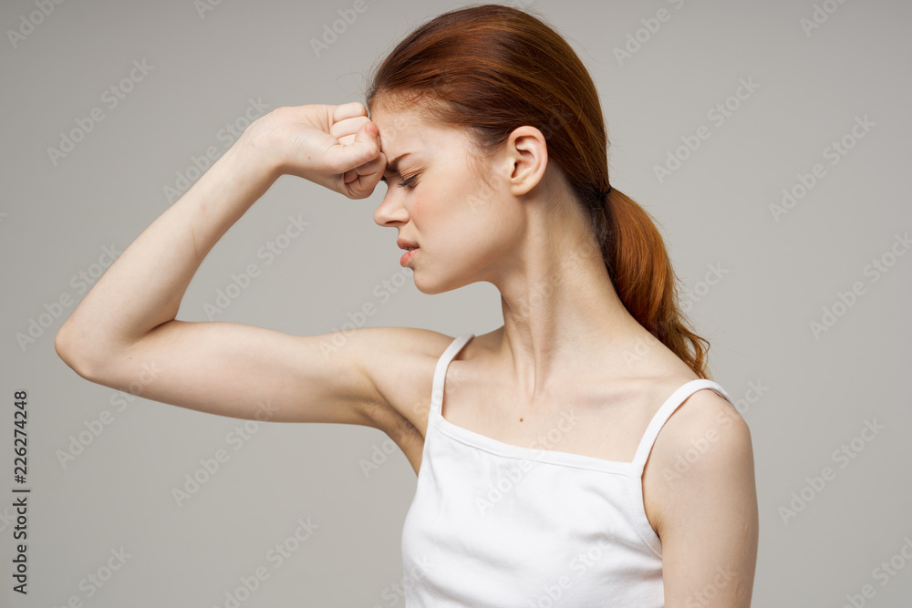 woman with closed eyes keeps fist on face woman with closed eyes keeps fist on face