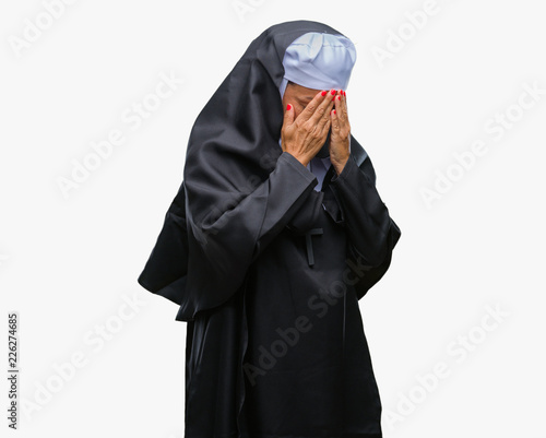 Middle age senior christian catholic nun woman over isolated background with sad expression covering face with hands while crying. Depression concept.