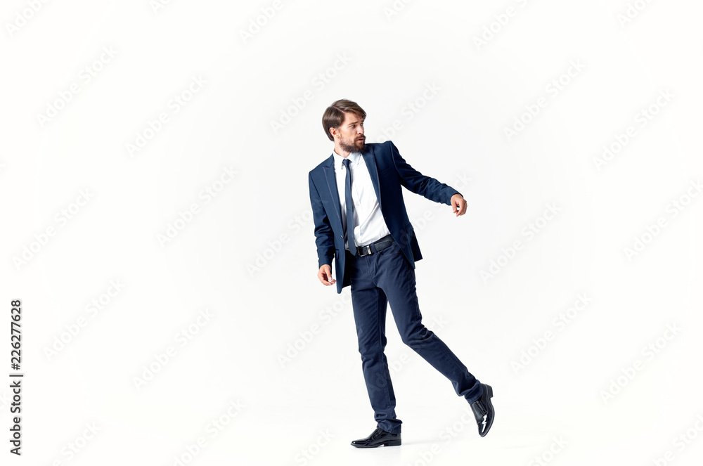 man in a suit with raised leg and arm man in a suit with raised leg and arm