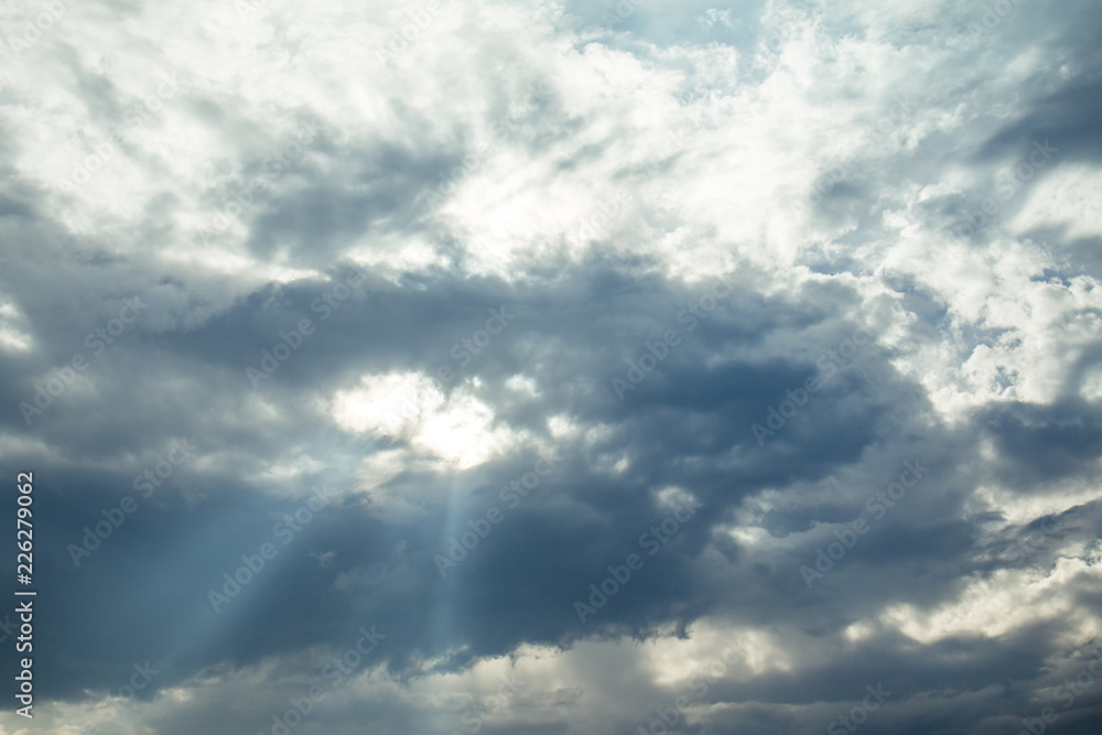Fototapeta premium light rays on dramatic moody blue sky