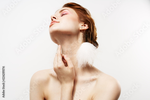 Canvas Print the woman tilted her head back and white earrings on her ears