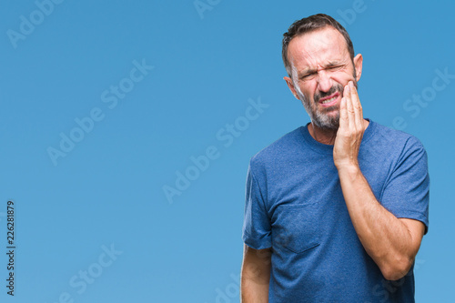 Middle age hoary senior man over isolated background touching mouth with hand with painful expression because of toothache or dental illness on teeth. Dentist concept. photo