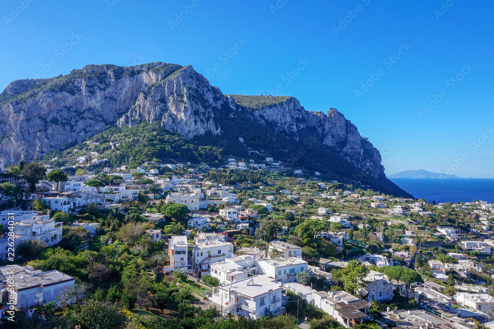 View of buildings in Isle of Capri, Italy with mountain in the background