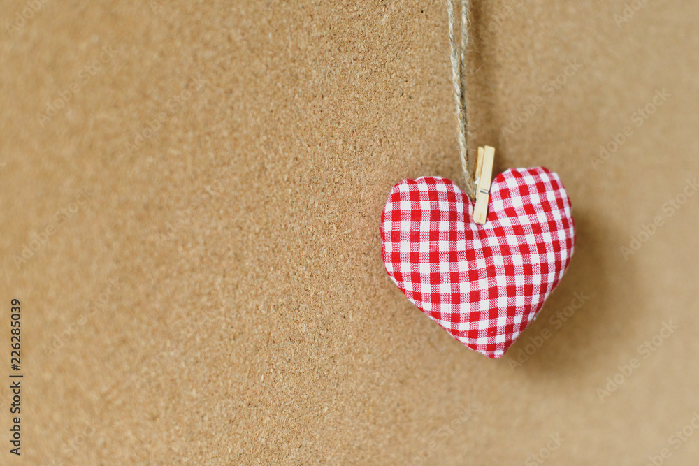 Red textile heart over brown craft recycle cork board background. Free copy space. Valentine's day concept. Red textile heart over brown craft recycle cork board background. Free copy space. Valentine's day concept.