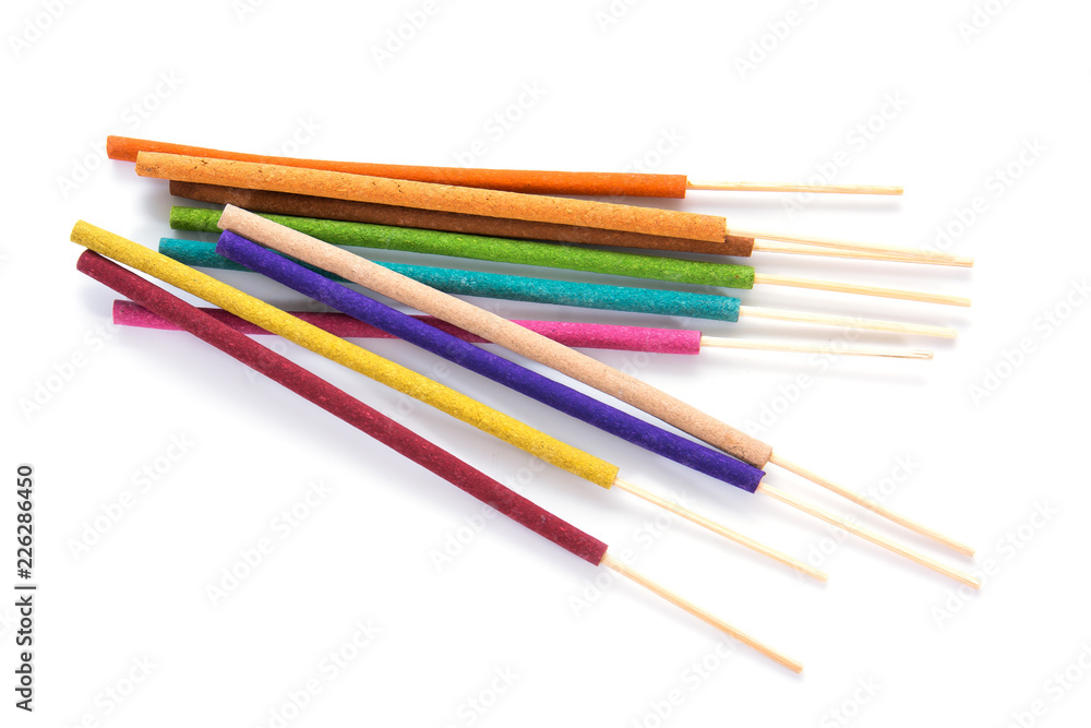 Closeup of colorful incense sticks isolated on white background