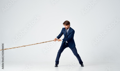 man in suit pulls the rope