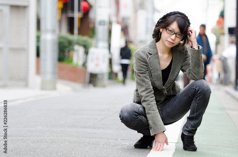 Japanese Girl poses on the street in Toranomon, Japan. Toranomon is a business district in Tokyo.